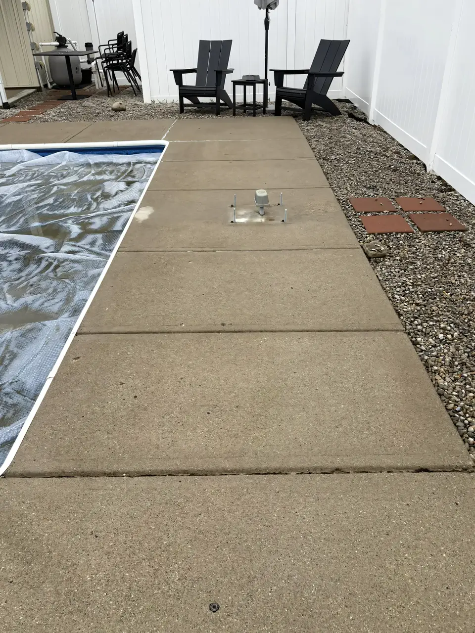 Same concrete patio surface after Stoltz pressure washing — clean, restored original color